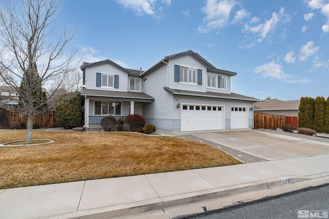 traditional home with covered porch, a front yard, fence, a garage, and driveway