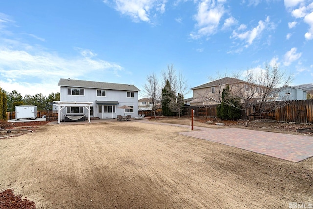 back of house featuring a patio area and a fenced backyard