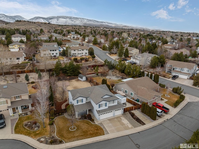 drone / aerial view featuring a residential view and a mountain view