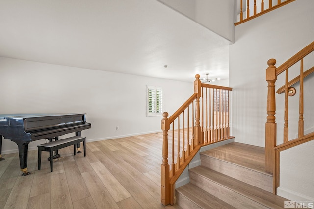 stairs with baseboards and wood finished floors