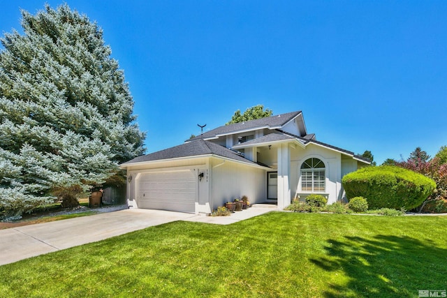 view of front of property with a garage, roof with shingles, driveway, and a front lawn