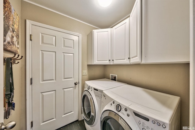 washroom with washing machine and dryer and cabinet space