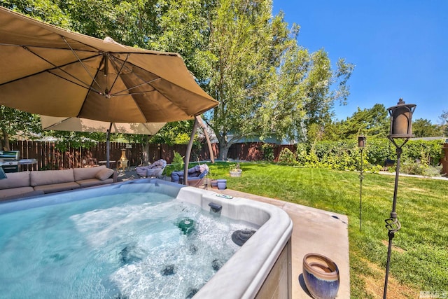 view of swimming pool with a yard, a fenced backyard, and a hot tub