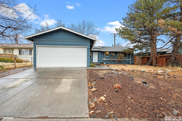 ranch-style home featuring an attached garage, fence, board and batten siding, and concrete driveway