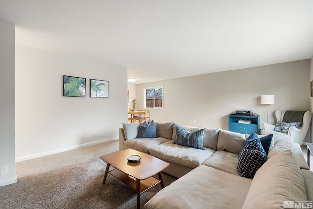 living room featuring carpet floors and baseboards