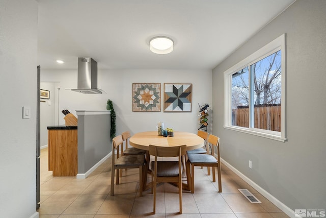 dining space with light tile patterned flooring, visible vents, and baseboards