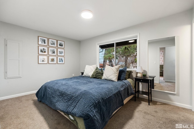 bedroom featuring light carpet and baseboards