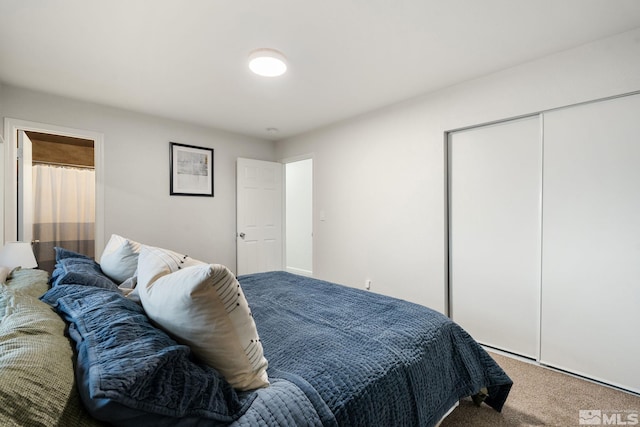 bedroom featuring a closet and carpet flooring