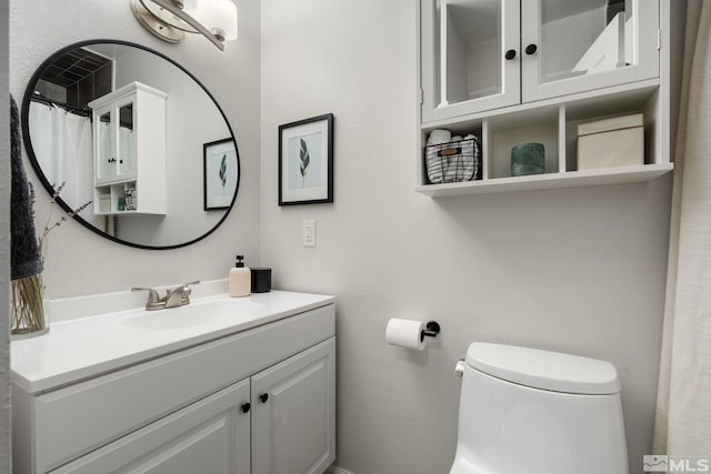 full bath featuring vanity and toilet