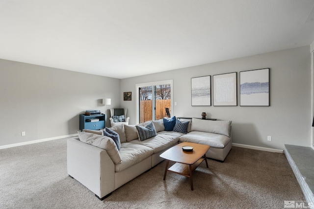 living area featuring carpet and baseboards