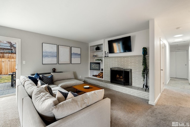 living area with baseboards, a fireplace, built in features, and light colored carpet