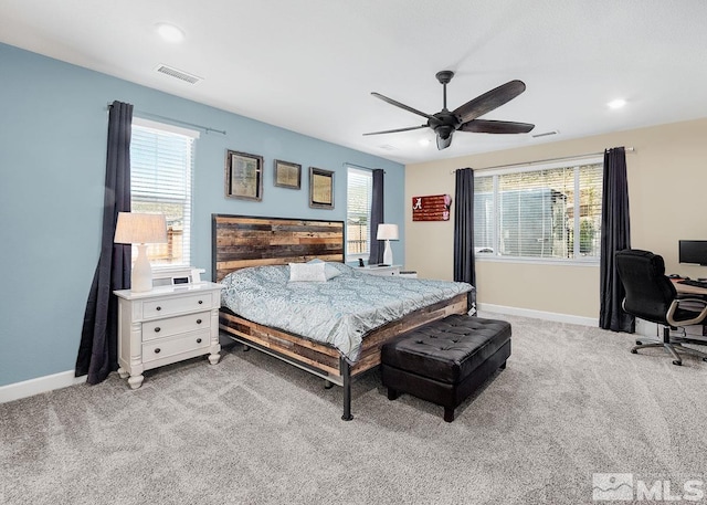 bedroom with a ceiling fan, visible vents, light carpet, and baseboards