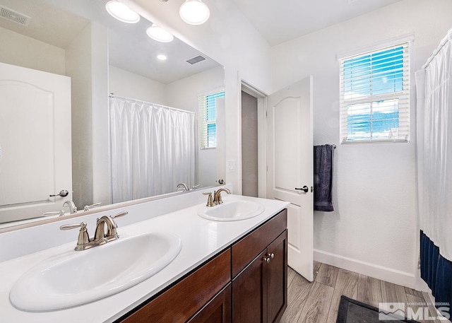 bathroom featuring a healthy amount of sunlight, visible vents, and a sink