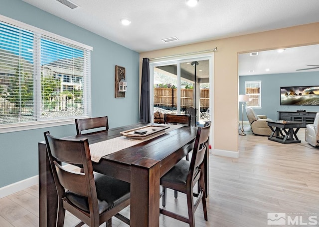 dining area with light wood-style floors, baseboards, visible vents, and recessed lighting