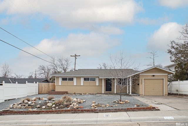 view of front facade featuring driveway, a garage, fence, and roof with shingles