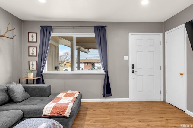 interior space featuring light wood-style flooring, baseboards, and recessed lighting