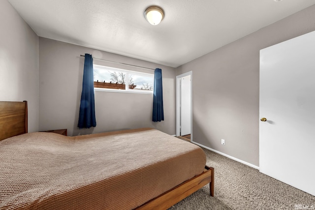 bedroom with baseboards and carpet flooring