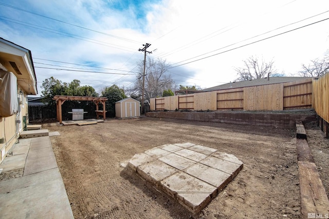 view of yard with an outbuilding, a storage unit, and a fenced backyard