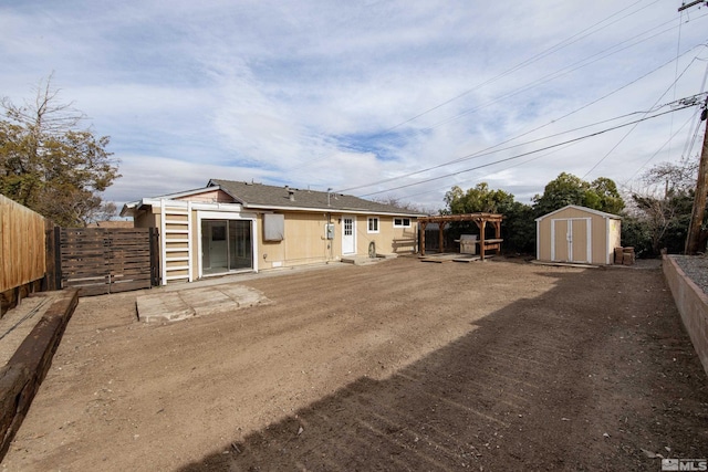 rear view of house featuring a storage shed, a fenced backyard, and an outdoor structure