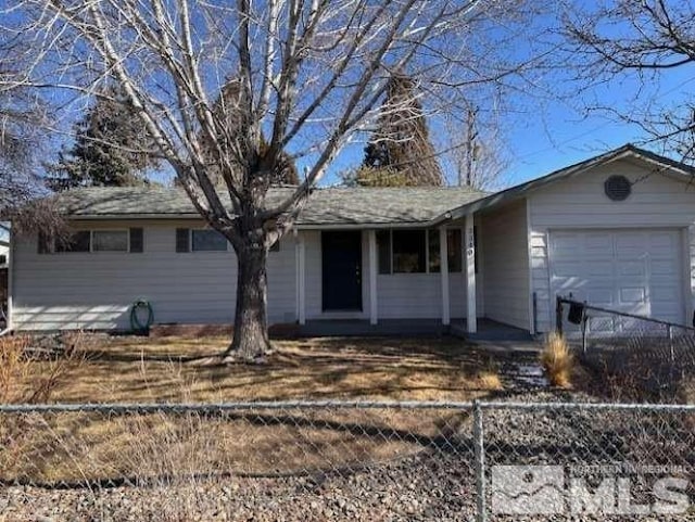 ranch-style house with an attached garage and fence