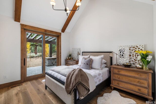 bedroom featuring visible vents, wood finished floors, access to exterior, a chandelier, and beam ceiling