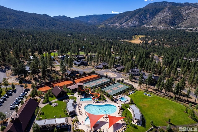 aerial view featuring a forest view and a mountain view