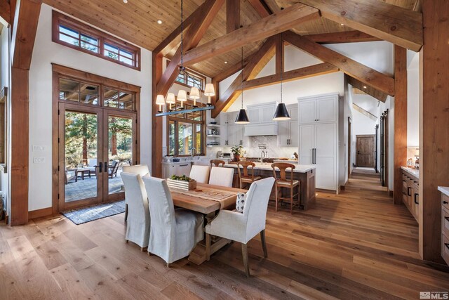 dining room featuring a chandelier, wood ceiling, french doors, and light wood finished floors