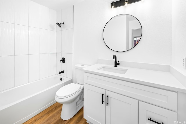 bathroom featuring tub / shower combination, vanity, toilet, and wood finished floors