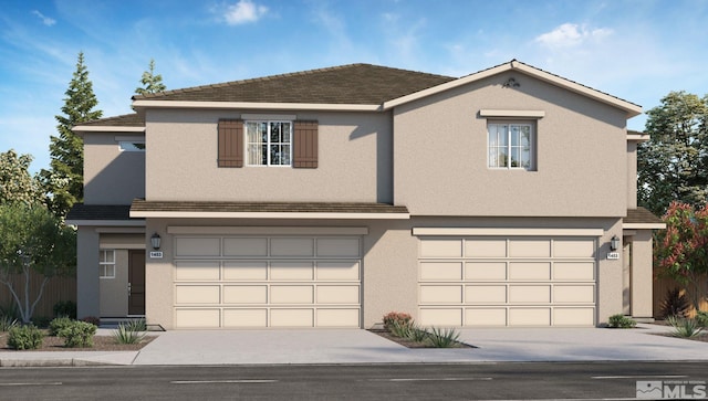 traditional home featuring a garage, driveway, and stucco siding