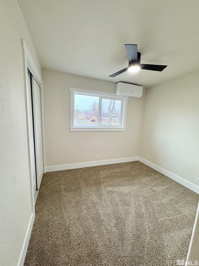 unfurnished bedroom with carpet, a closet, baseboards, and an AC wall unit