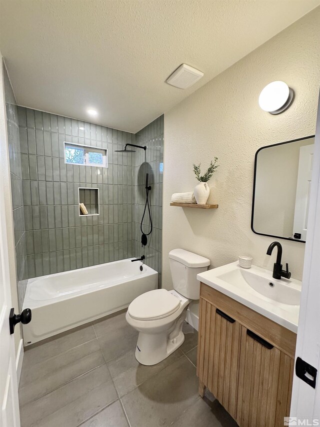 full bathroom with vanity, a textured ceiling, toilet, and tile patterned floors