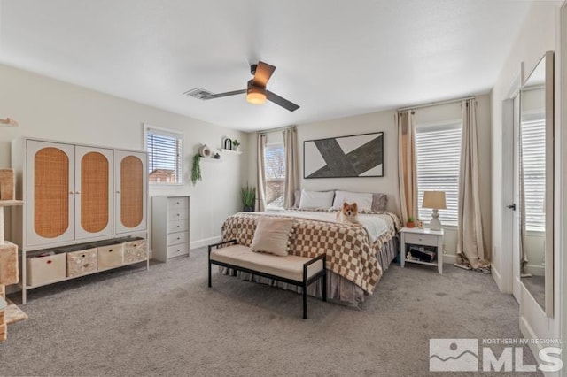 bedroom featuring baseboards, carpet floors, visible vents, and a ceiling fan