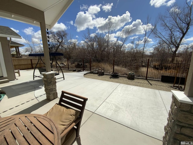 view of patio featuring fence