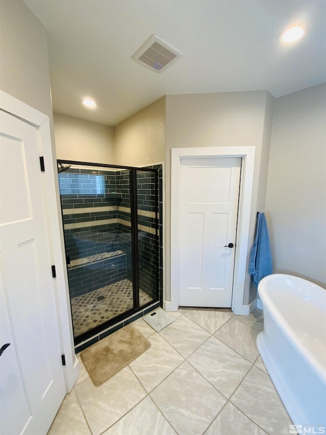 bathroom with a stall shower, visible vents, tile patterned flooring, a freestanding bath, and recessed lighting