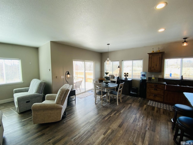 dining space featuring recessed lighting, dark wood finished floors, a textured ceiling, and baseboards