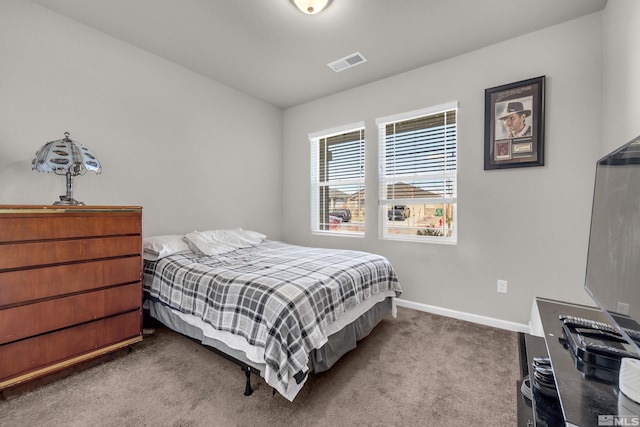 carpeted bedroom featuring visible vents and baseboards