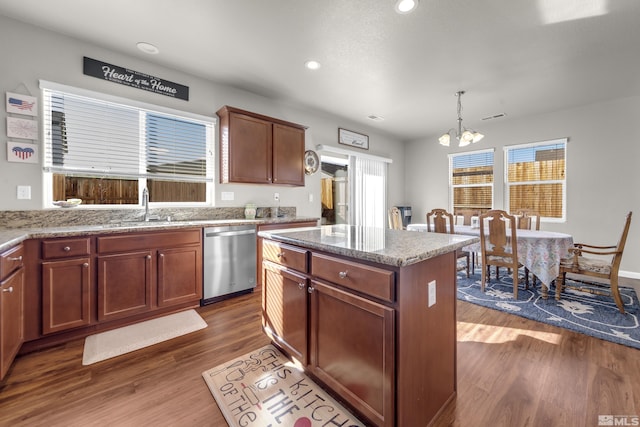 kitchen featuring a sink, dishwasher, a chandelier, and dark wood-style flooring