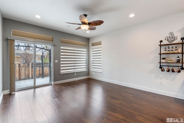 empty room with recessed lighting, ceiling fan, baseboards, and wood finished floors