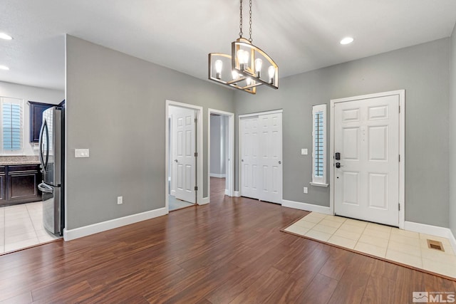 entrance foyer featuring baseboards, light wood-type flooring, visible vents, and recessed lighting