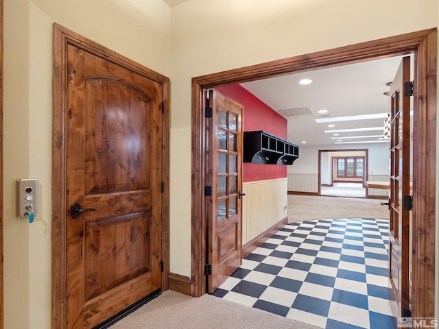 corridor with recessed lighting, wainscoting, visible vents, and tile patterned floors