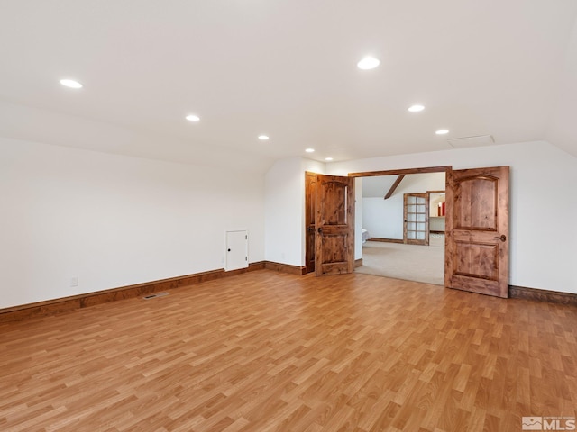 additional living space with lofted ceiling, light wood-style flooring, baseboards, and recessed lighting