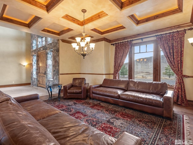 living room featuring baseboards, a chandelier, coffered ceiling, and beamed ceiling