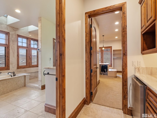 bathroom featuring a walk in shower, a garden tub, recessed lighting, beverage cooler, and tile patterned floors