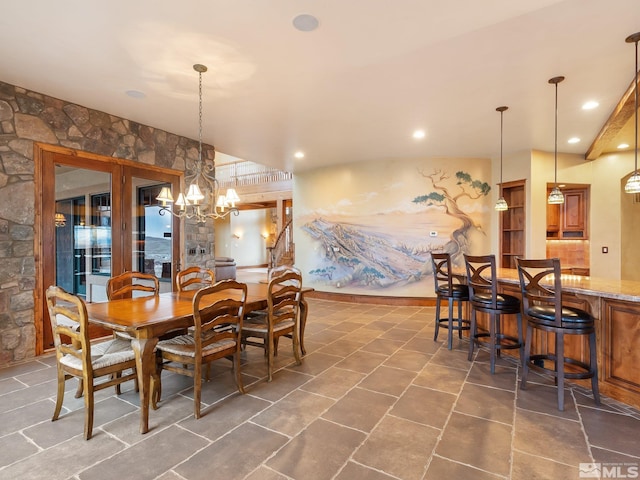 dining room with a chandelier, indoor bar, and recessed lighting