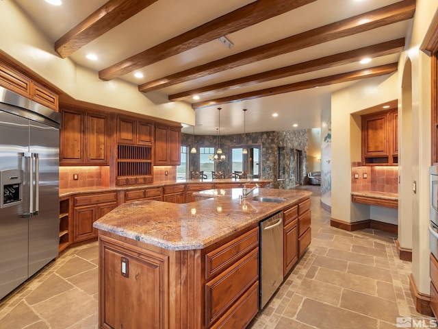 kitchen with appliances with stainless steel finishes, brown cabinetry, decorative backsplash, and stone tile floors