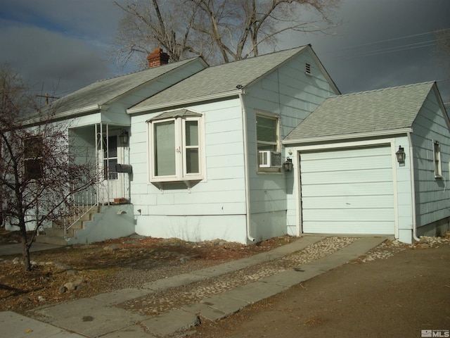 view of side of property with a garage, cooling unit, roof with shingles, and a chimney