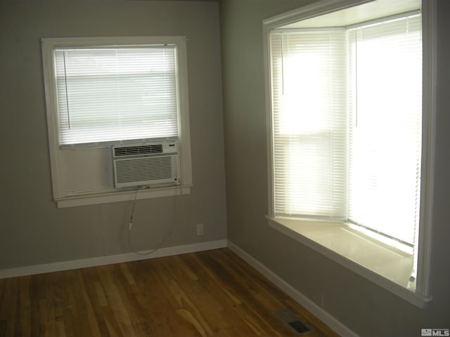 unfurnished room featuring baseboards and wood finished floors