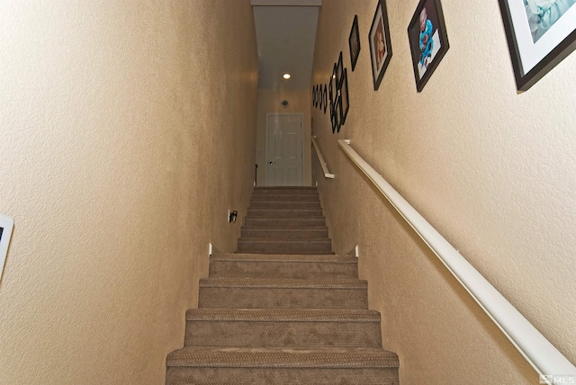 staircase with a textured wall