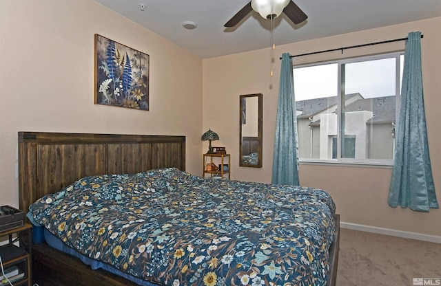 carpeted bedroom with a ceiling fan and baseboards