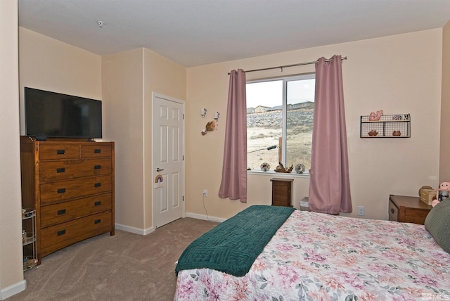 bedroom with carpet flooring and baseboards